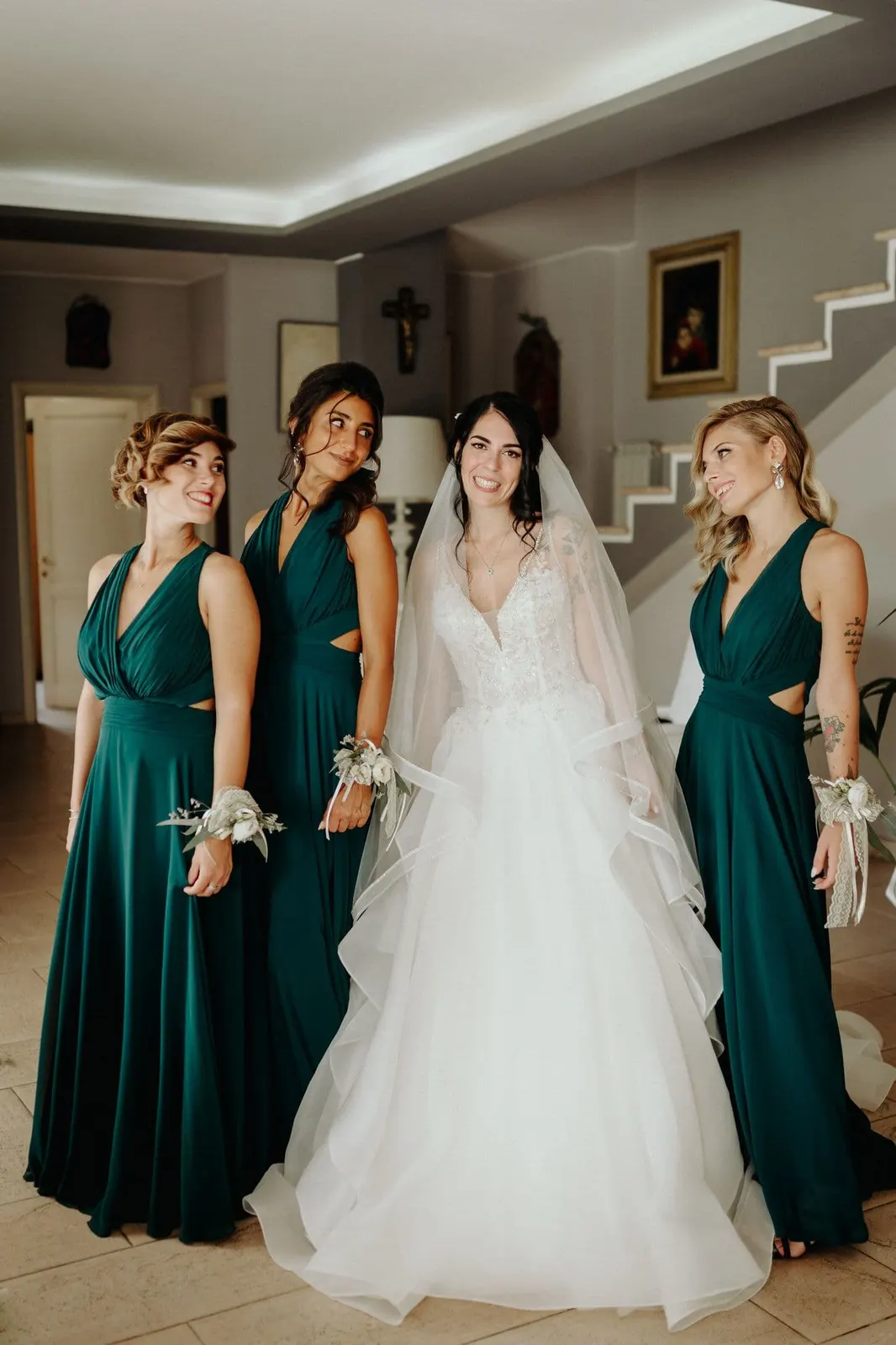Micaela in her wedding dress among the bridesmaids in forest green