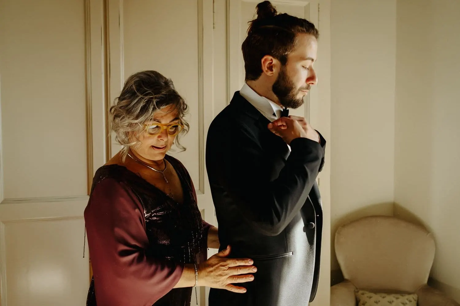 Raffaele's mother helping him into his jacket
