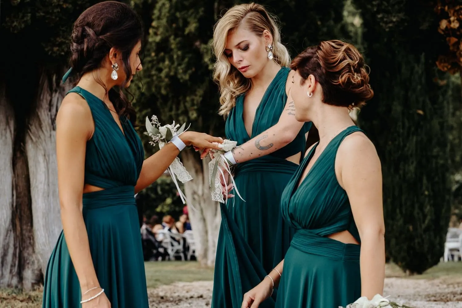 The bridesmaids adjusting their flower corsages before the ceremony