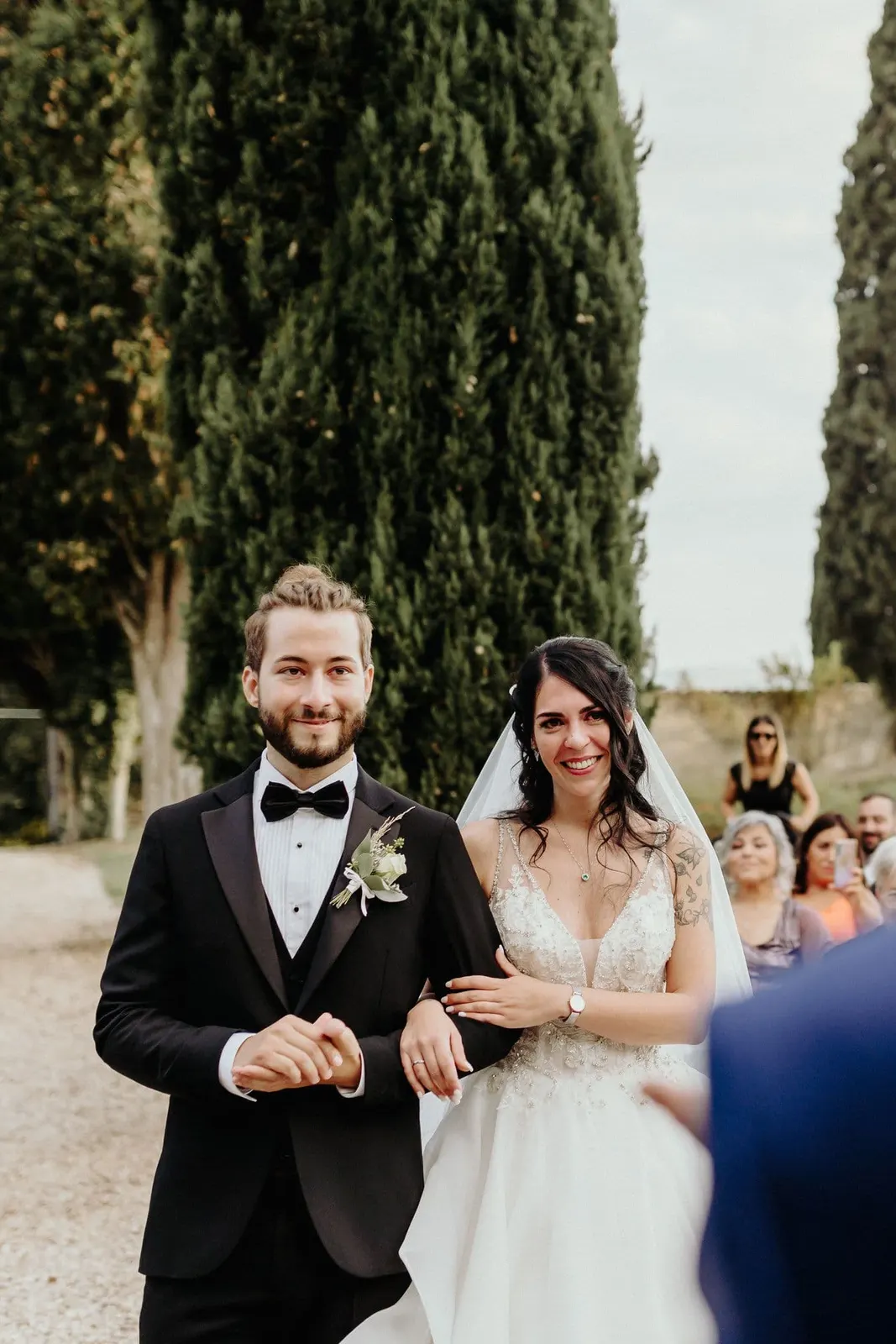 The couple arm in arm, laughing during the ceremony