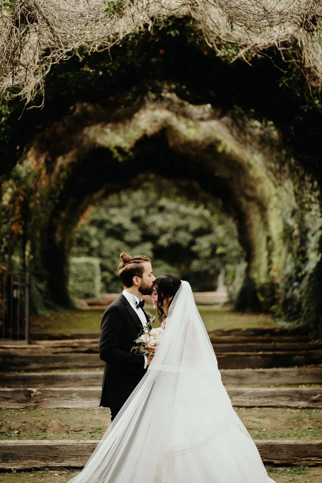 The couple under the tunnel of trees in the park at San Pietro Sopra le Acque