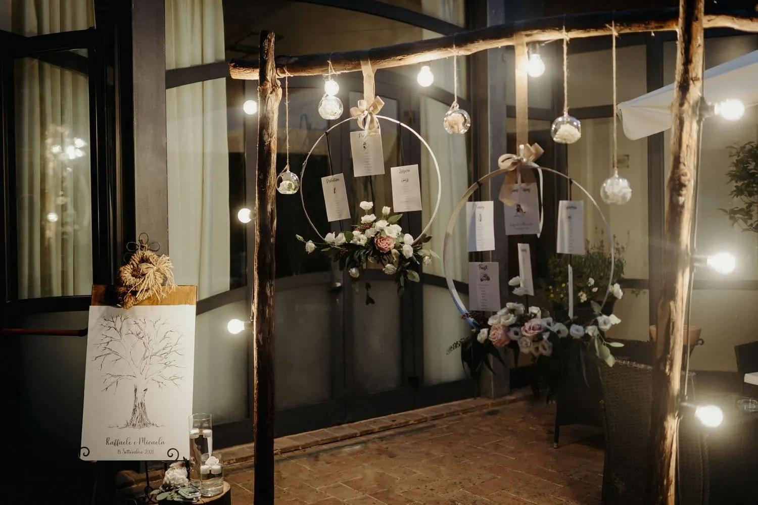 The seating plan hanging from metal hoops among the light bulbs