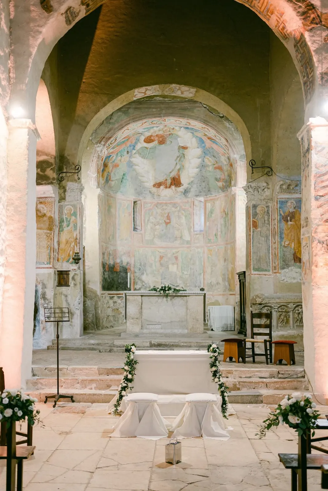 The frescoed apse of the church of San Pietro in Valle, dressed for the ceremony