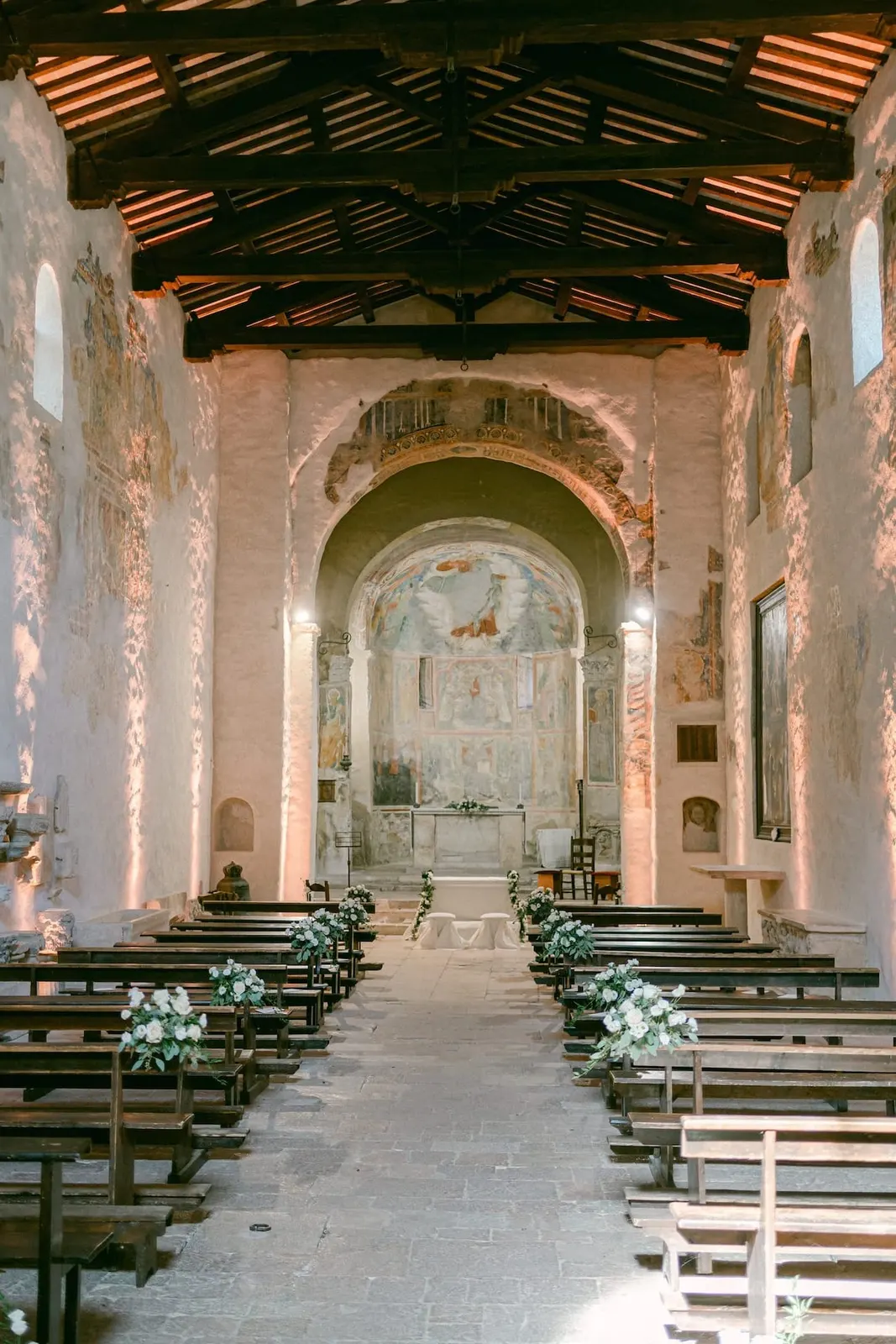 The nave of the church with its timber trusses and frescoed walls