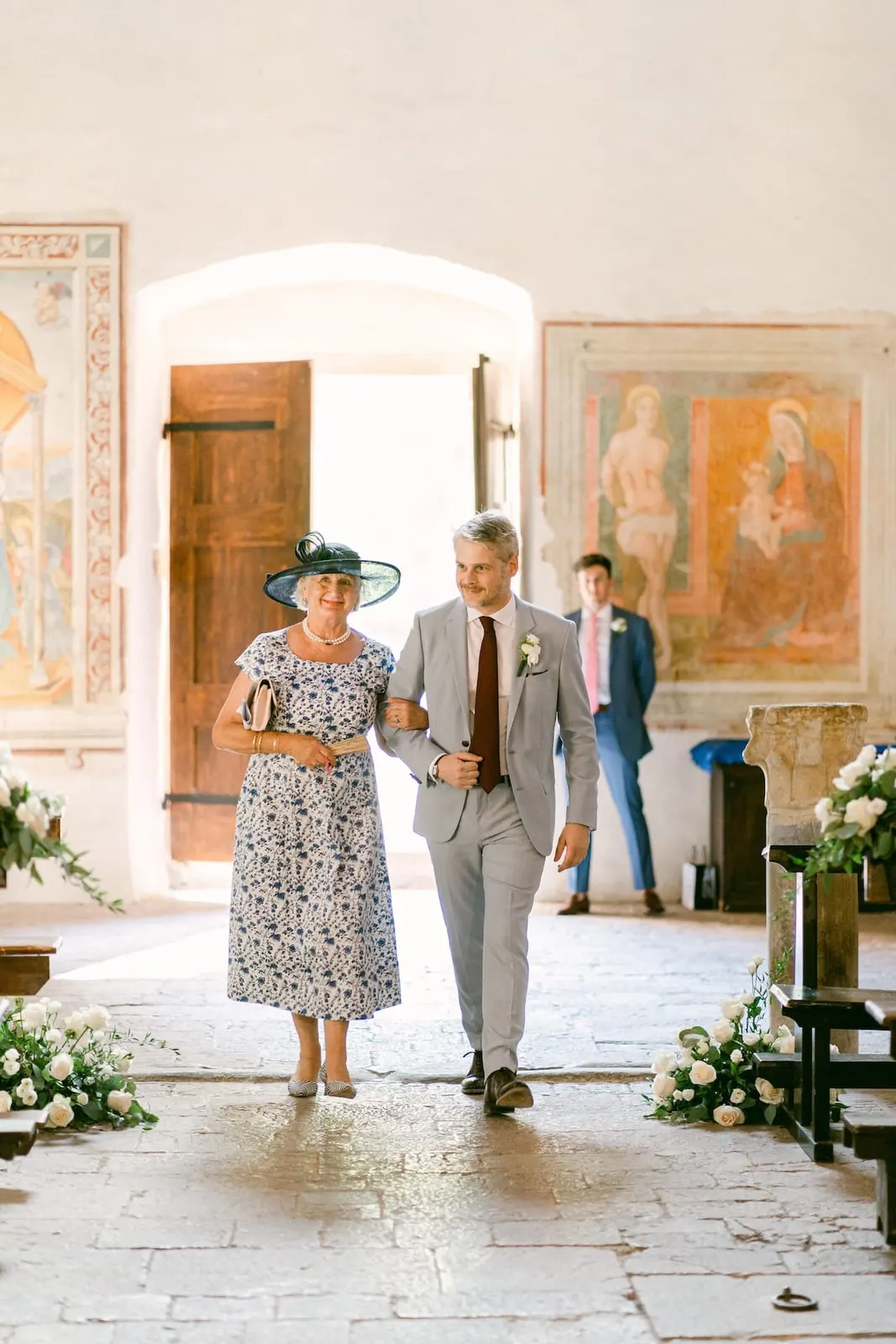 Thomas walking into church on his mother's arm