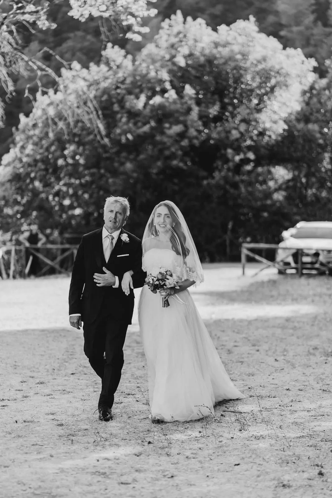 Valentina arriving at the abbey on her father's arm, in black and white