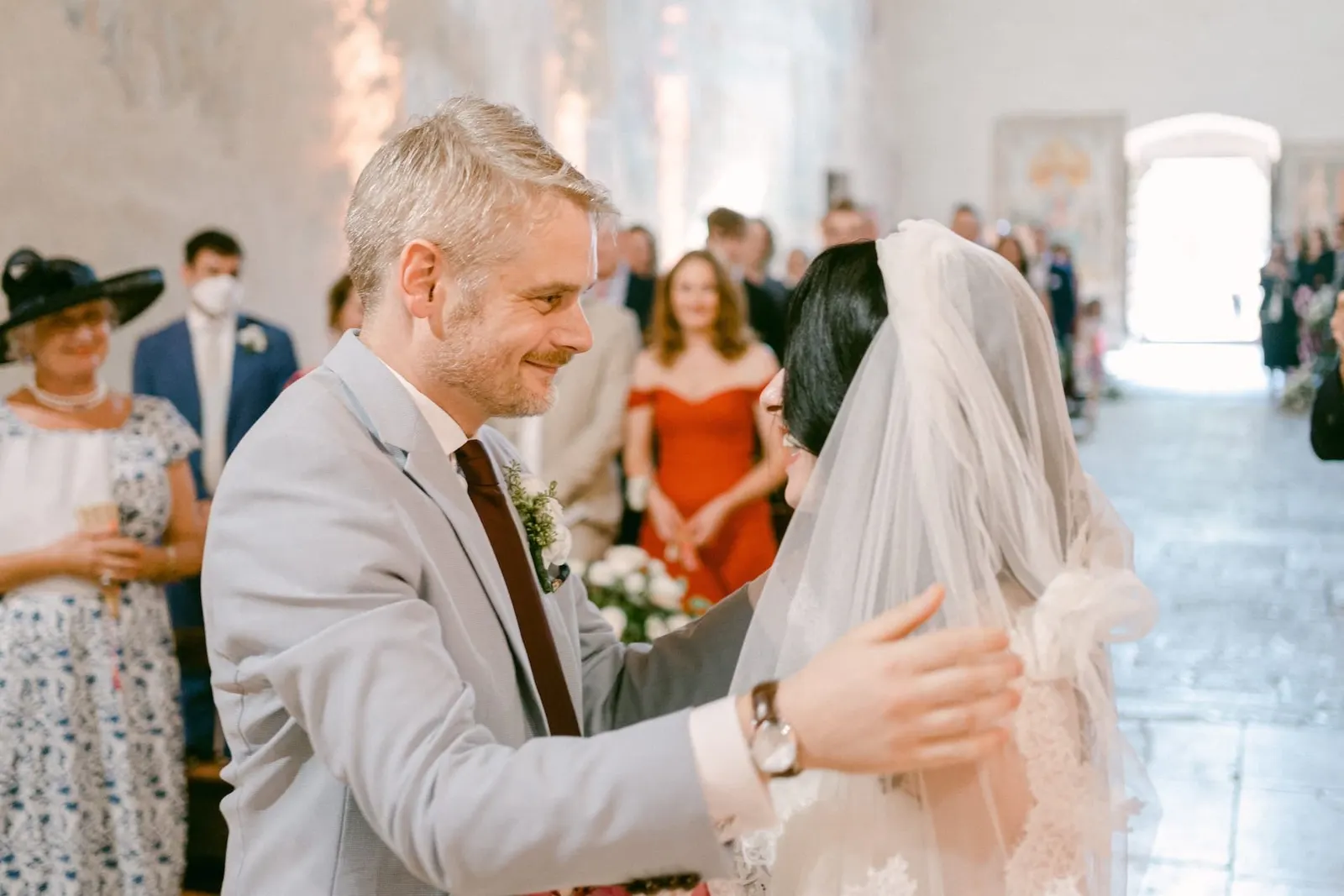 Thomas greeting Valentina at the altar, touching her veil