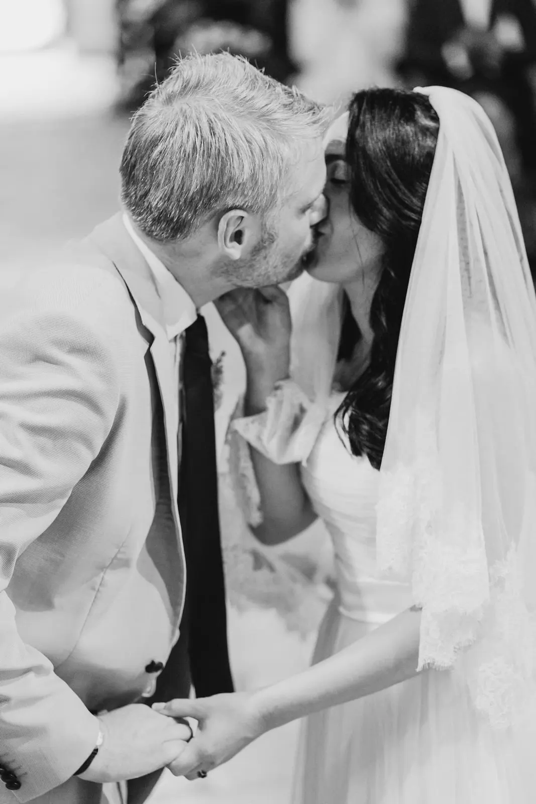 The couple's kiss during the ceremony, in black and white