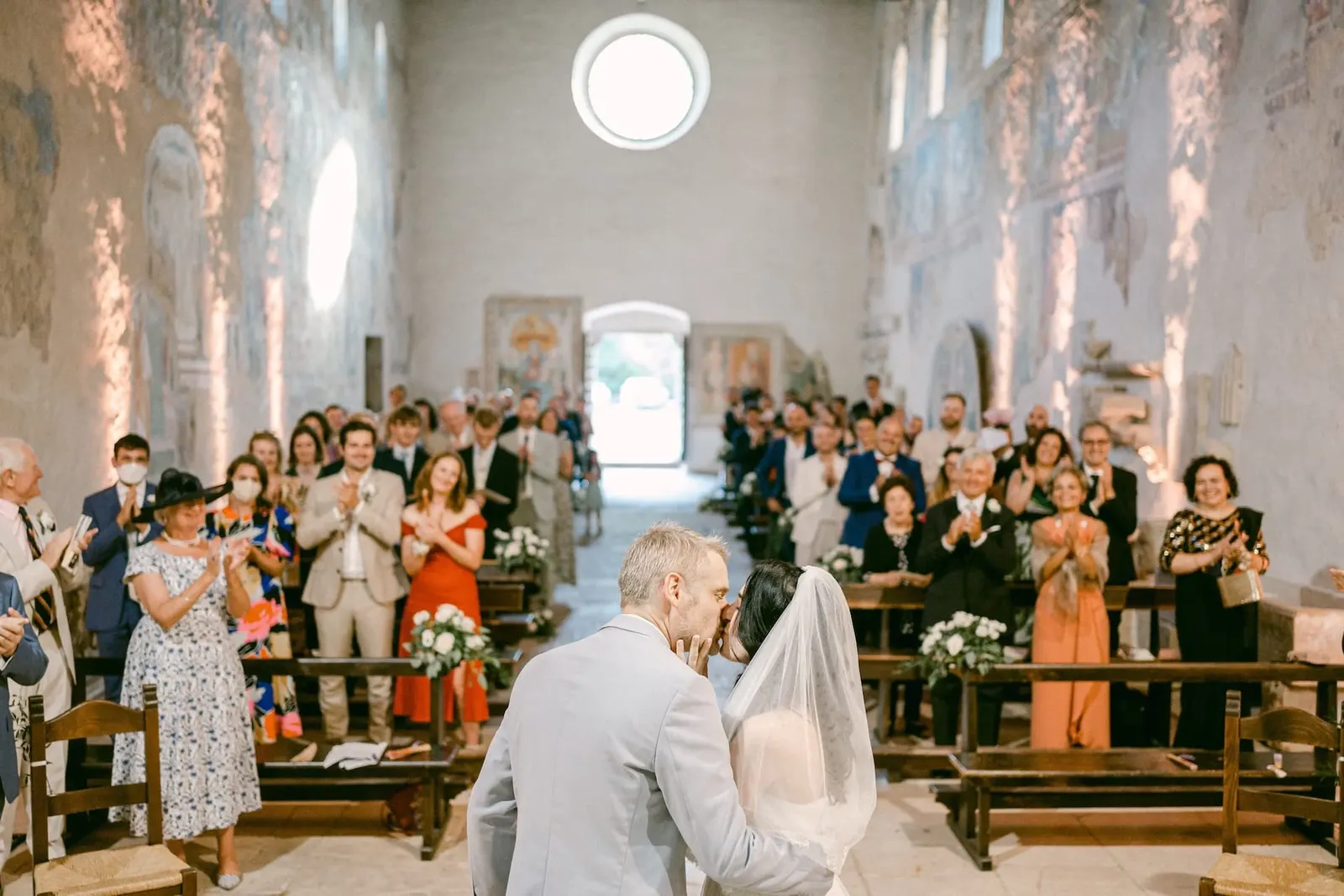 The guests applauding the couple at the end of the ceremony