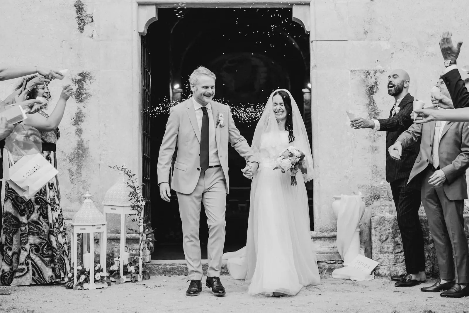 The couple leaving the church to applause, in black and white