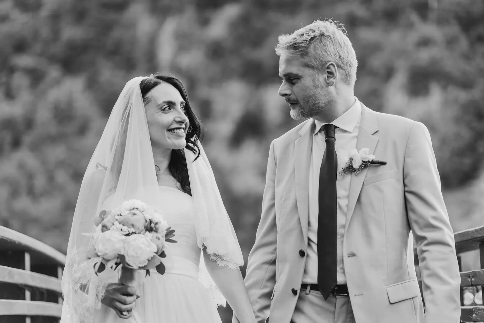 Valentina and Thomas smiling at each other, in black and white