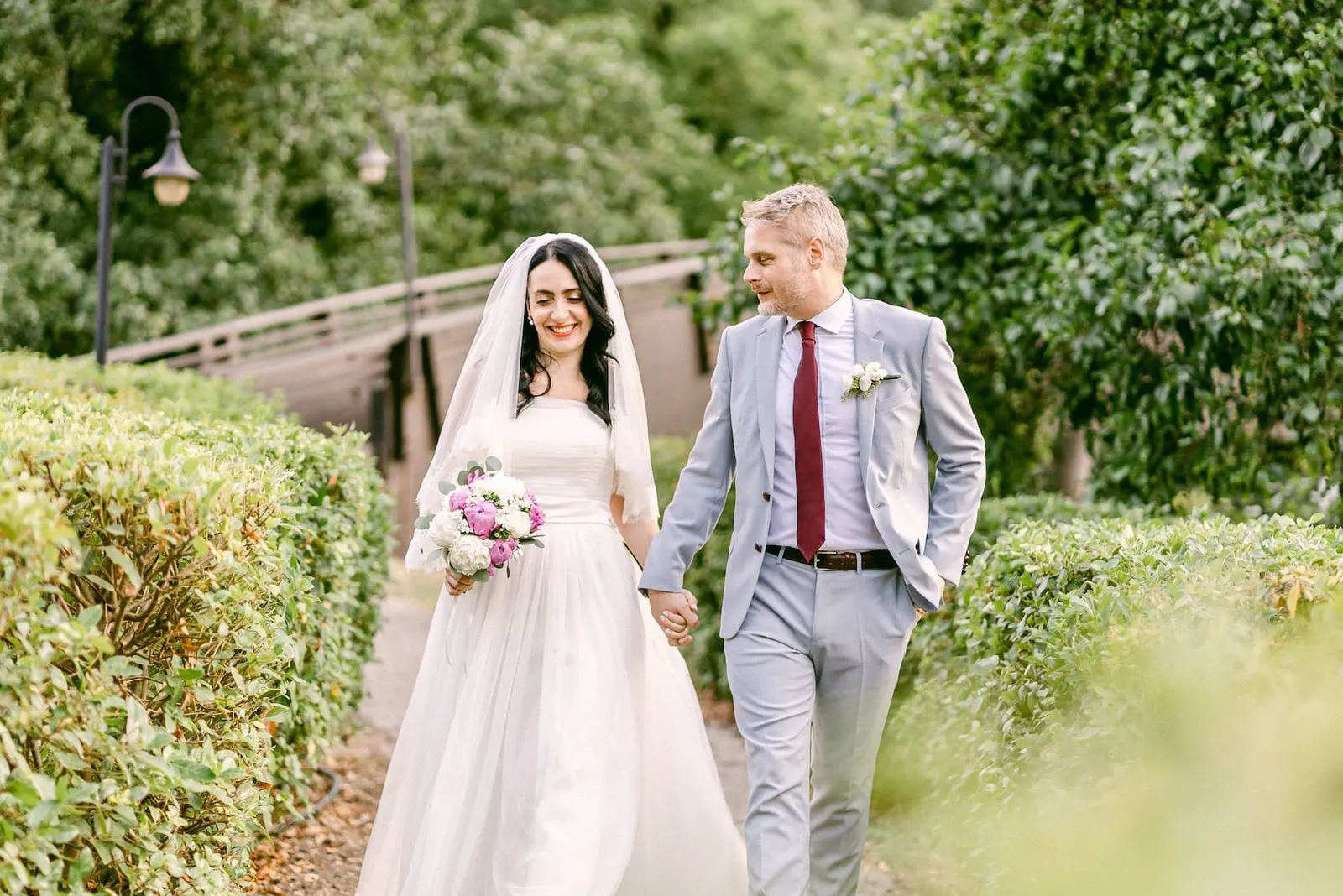 Valentina and Thomas strolling hand in hand among the greenery