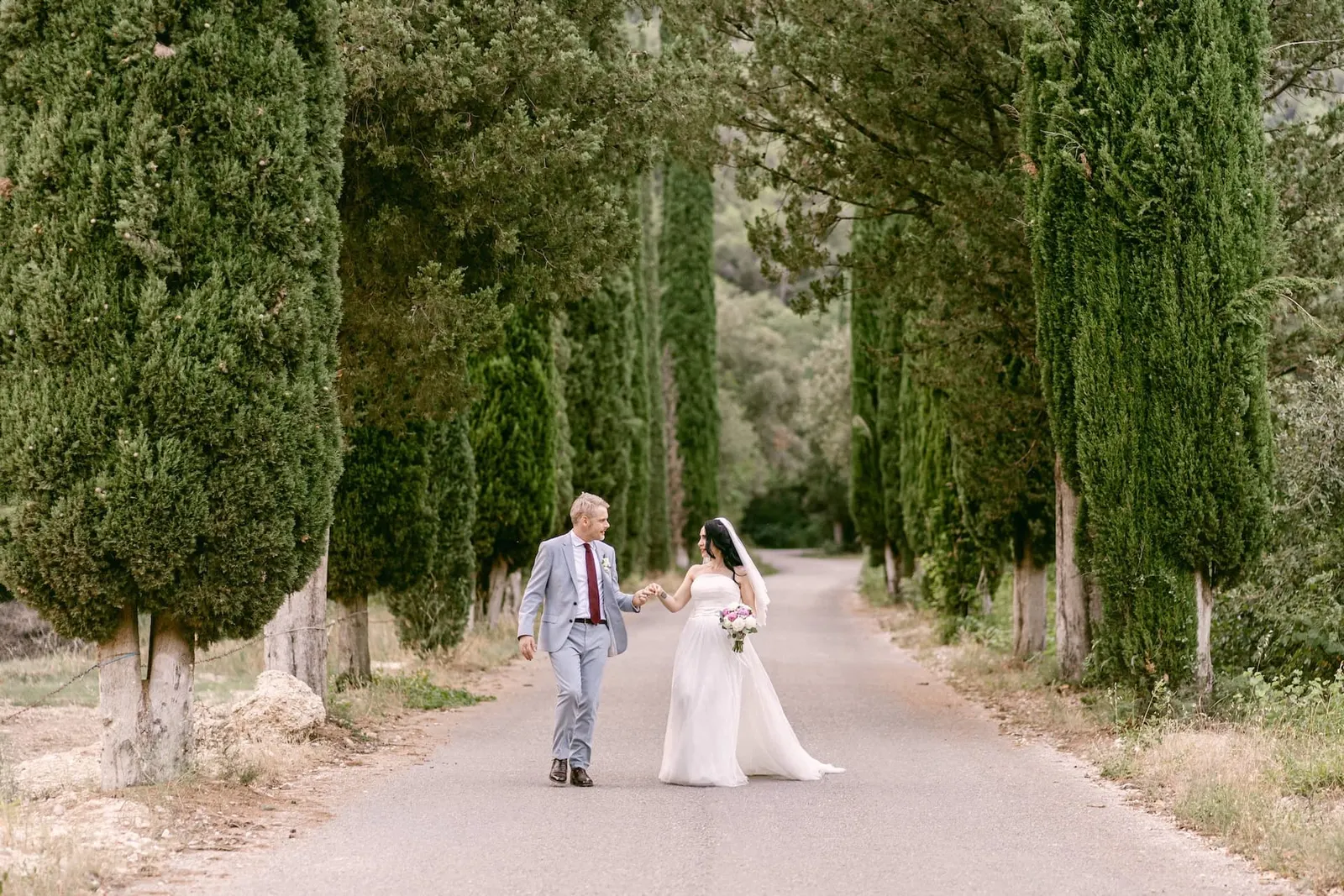The couple in the cypress avenue that climbs to Abbazia San Pietro in Valle