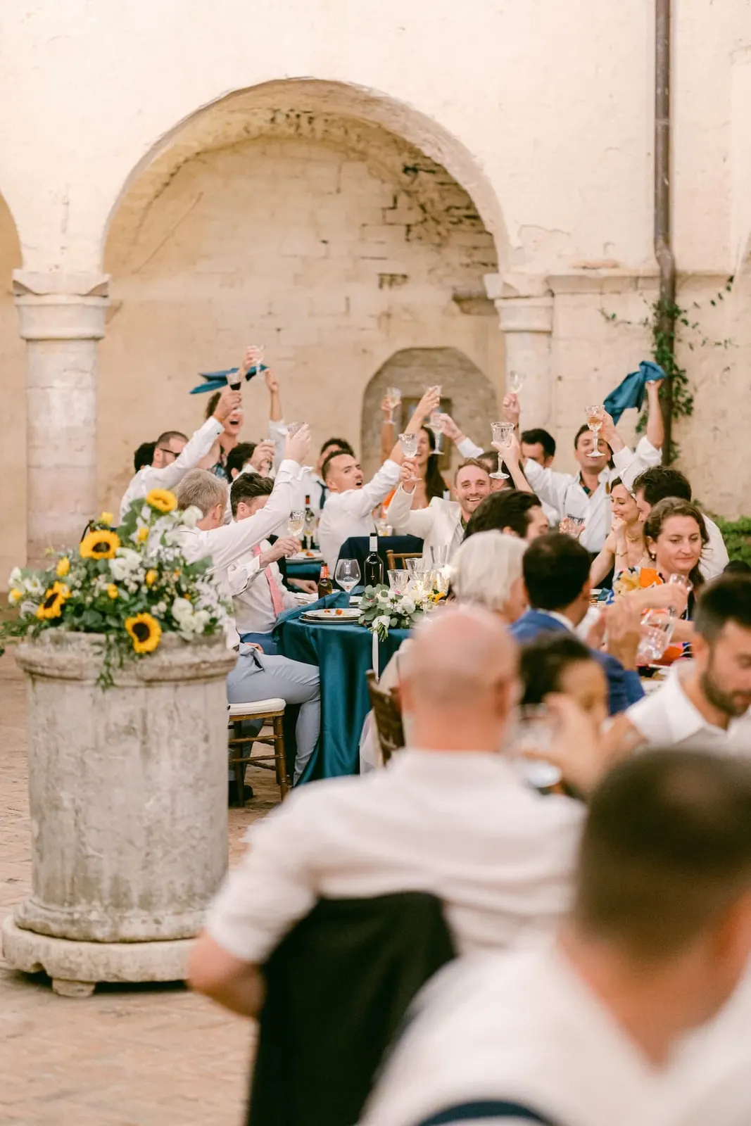 Guests waving their napkins among the tables in the cloister