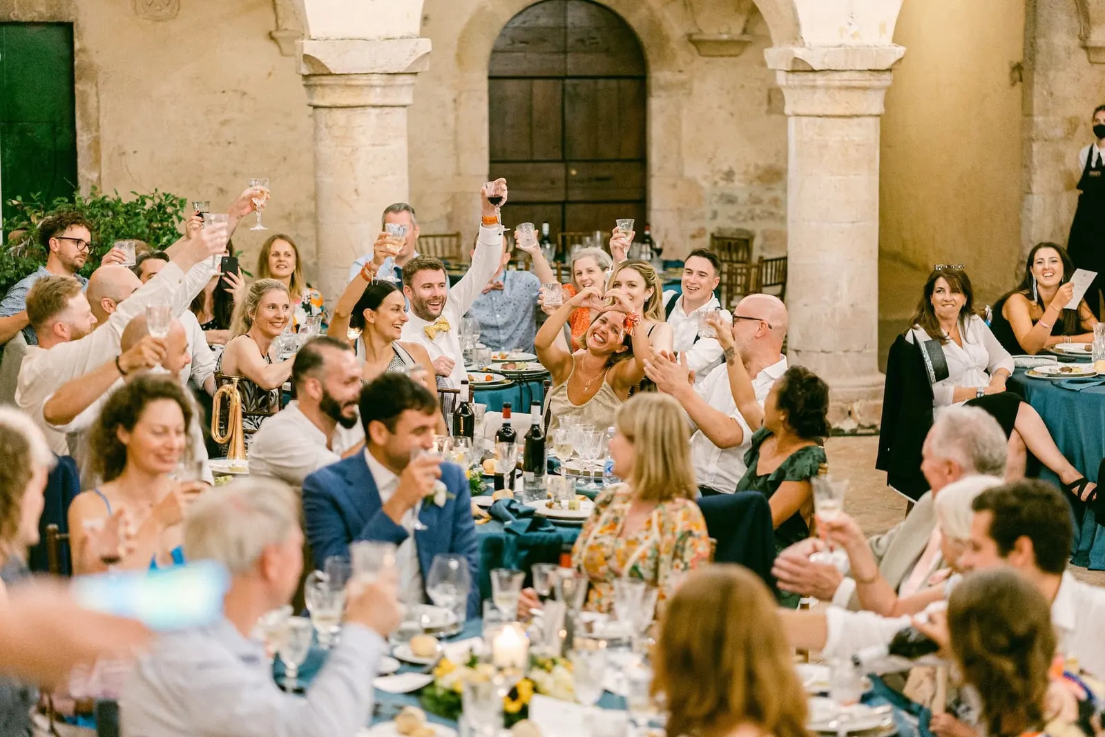 The guests raising a toast at the table