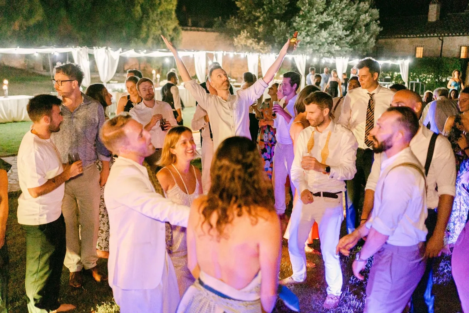 The dance floor on the lawn under the string lights
