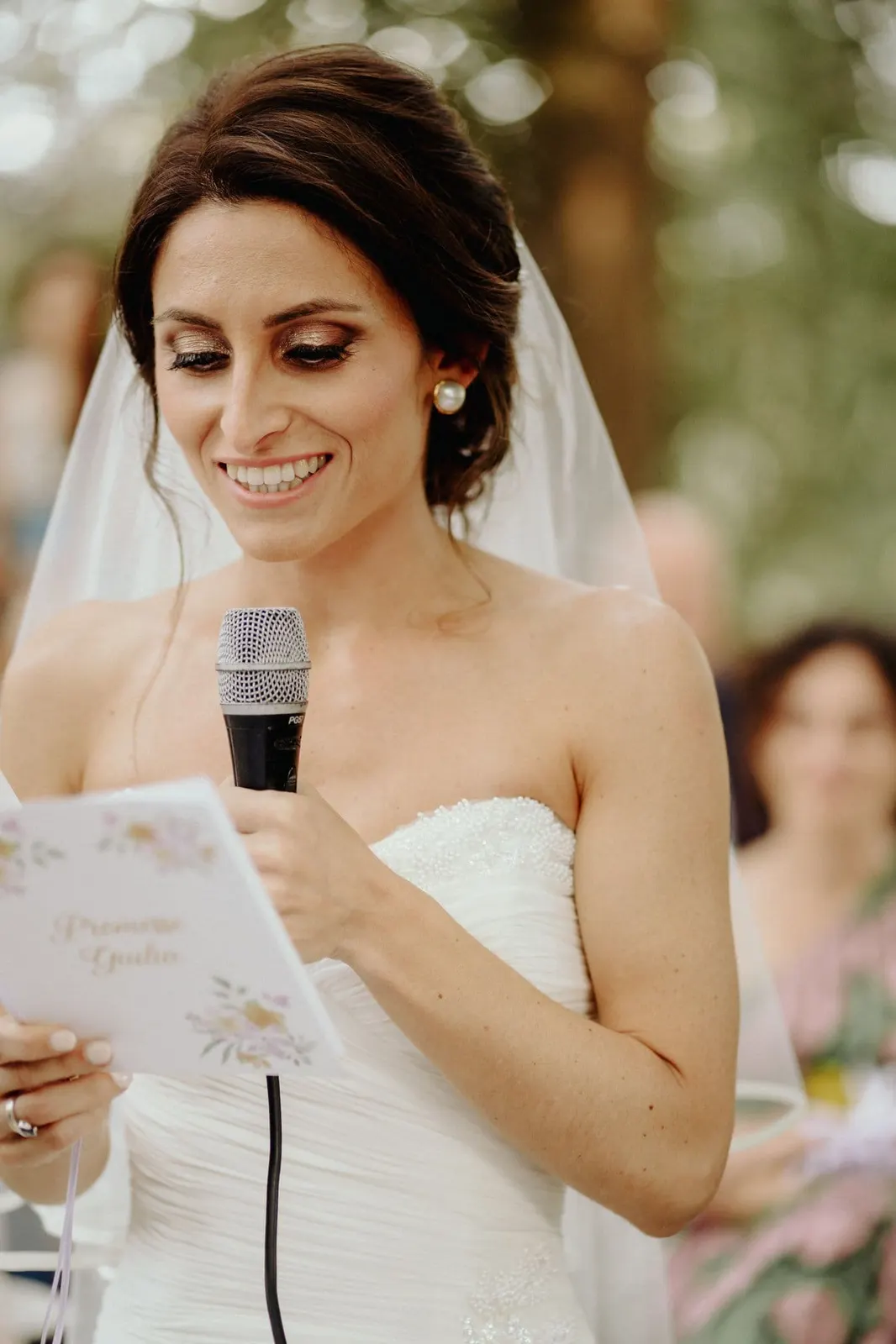 Giulia reading her vows at the microphone