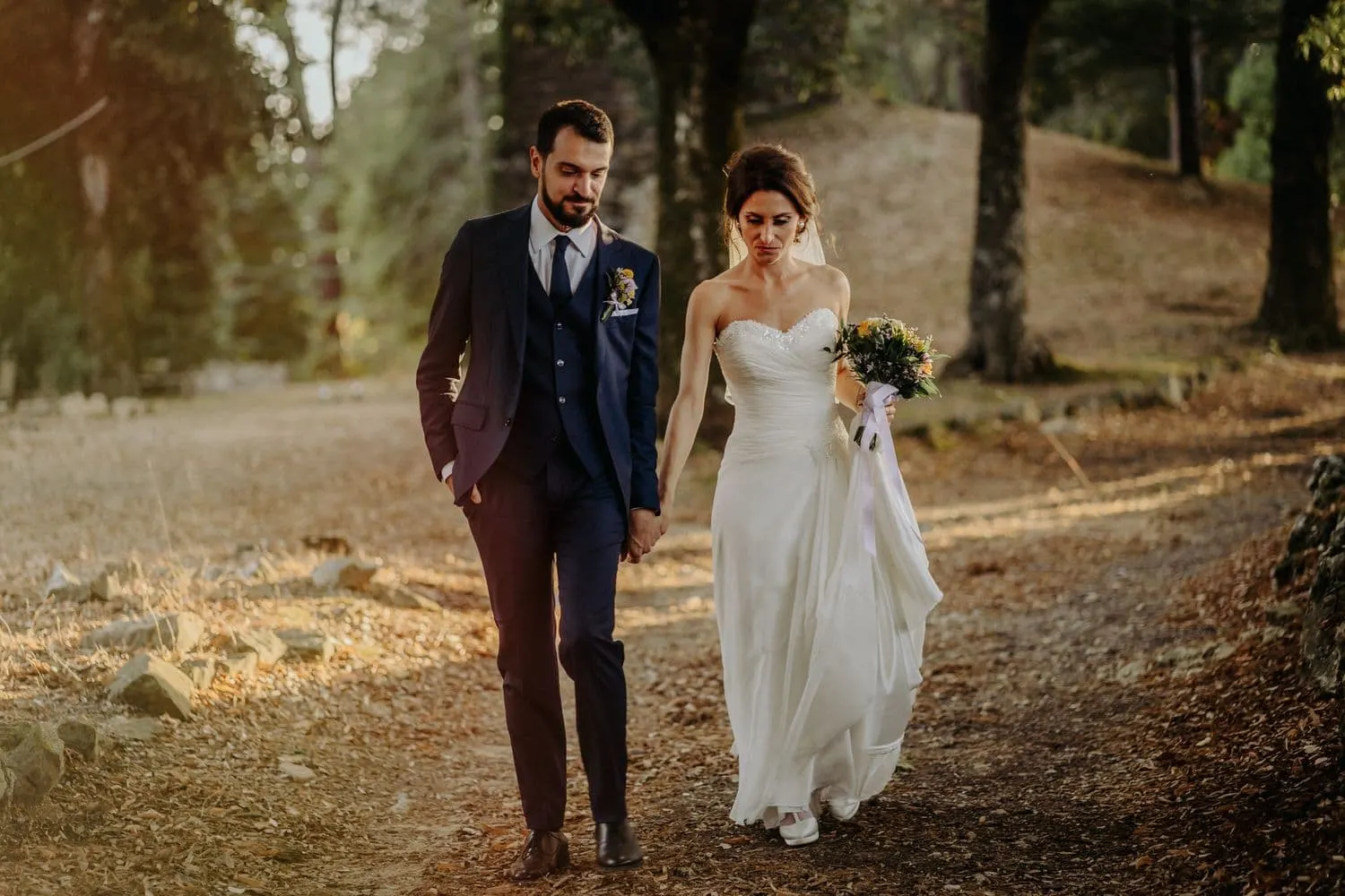 Giulia and Francesco walking in the woods in late afternoon light